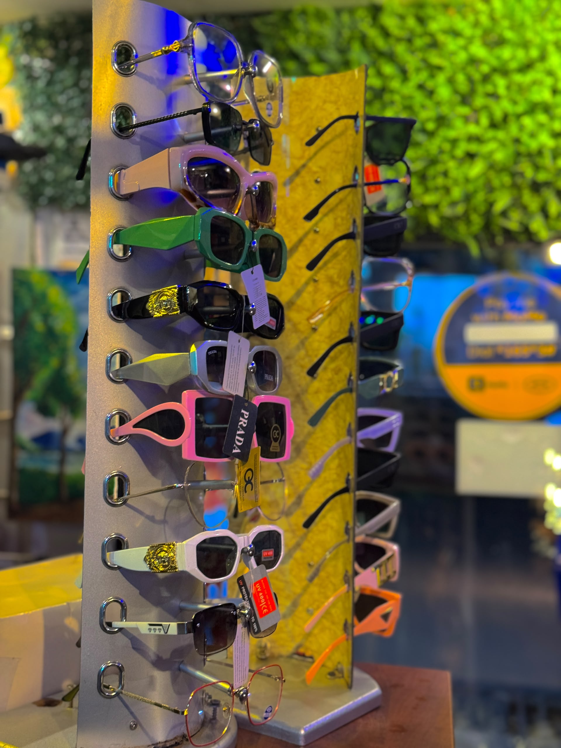 Sunglasses display — Prada style, green, pink
